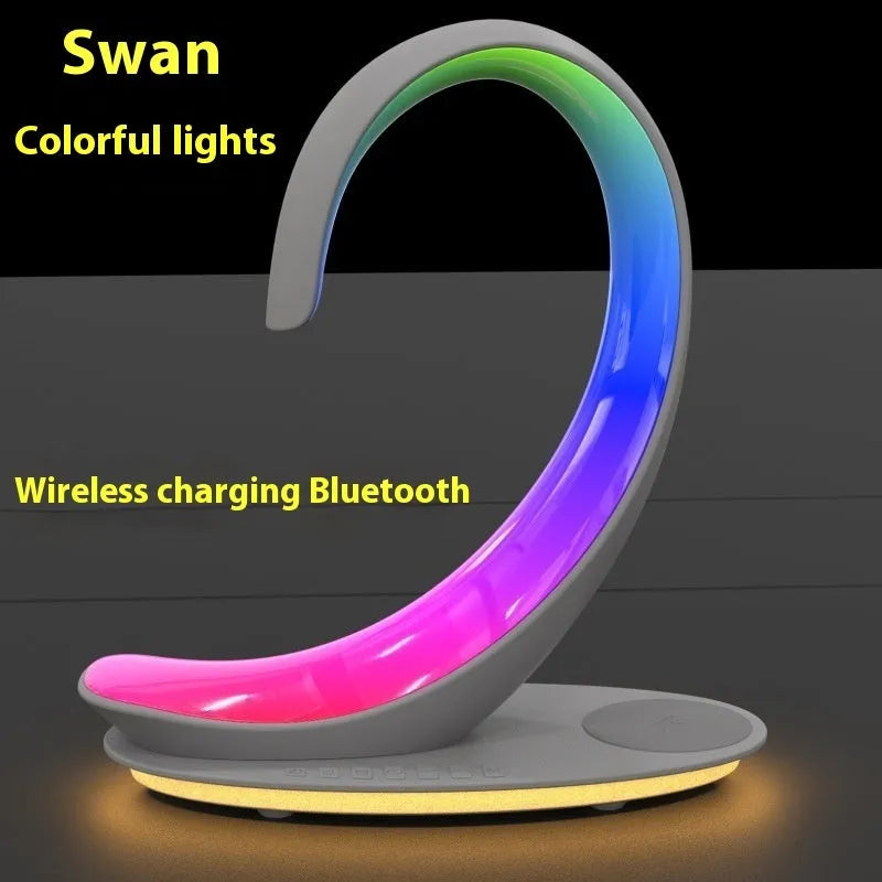 White swan-shaped desk lamp with colourful LEDs, integrated wireless charger, and Bluetooth speaker.