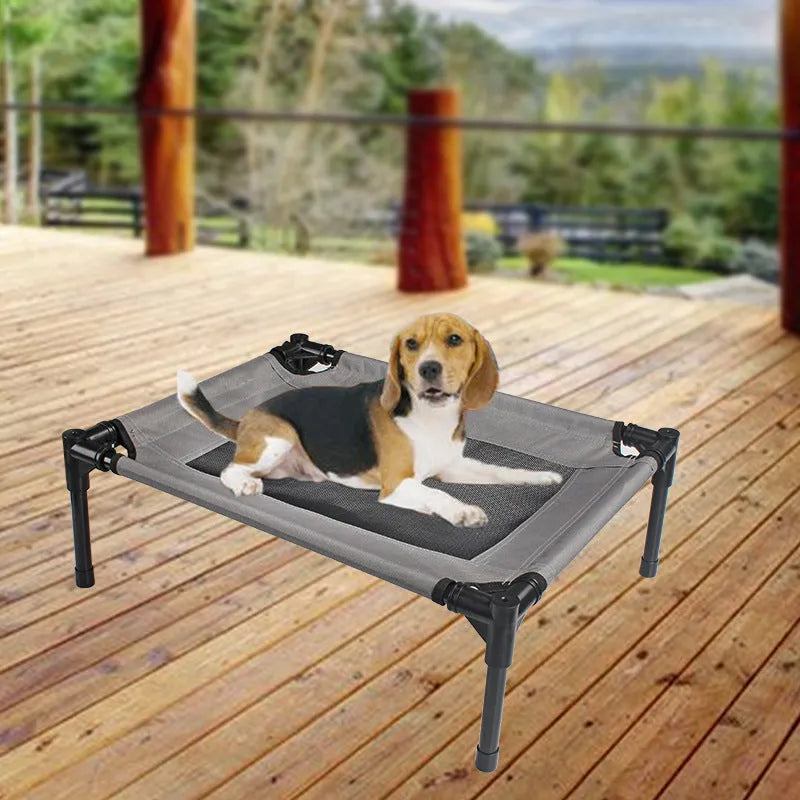Black portable outdoor dog bed with removable washable cover and steel frame, shown on grass.