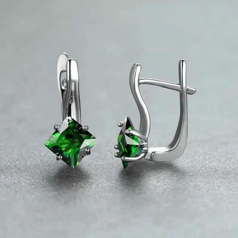 A pair of simple copper earrings with a diamond design created from inlaid zircon stones.