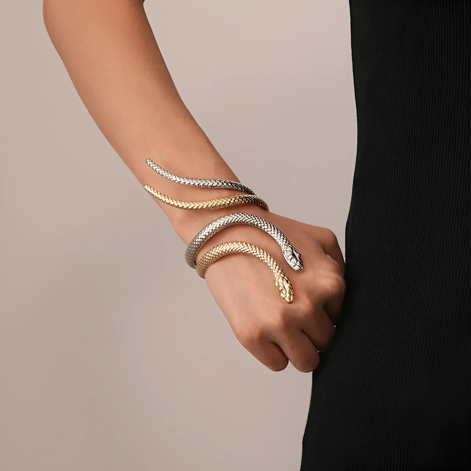 Gold metal snake-inspired ring and bracelet set with exaggerated twisted winding design