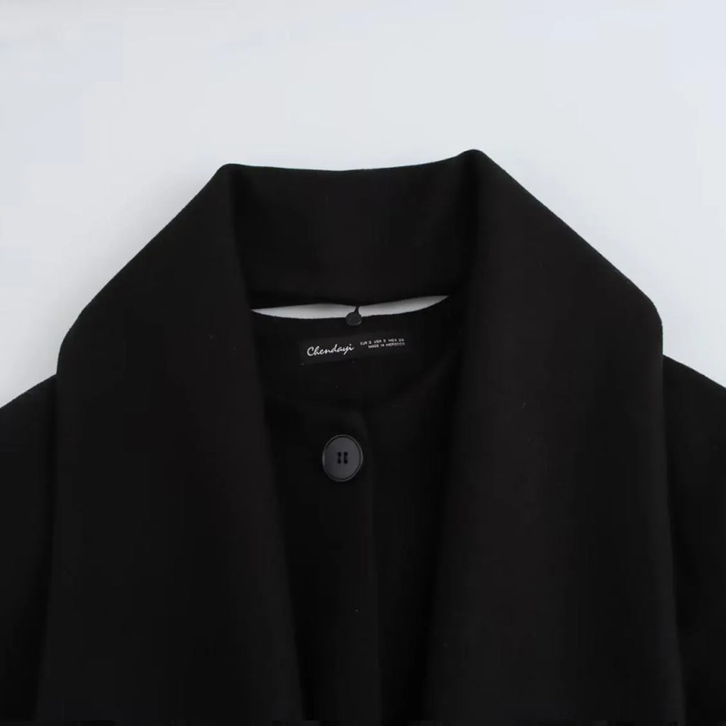 Women's long black polyester overcoat with a detachable artificial fur collar in a street fashion style.