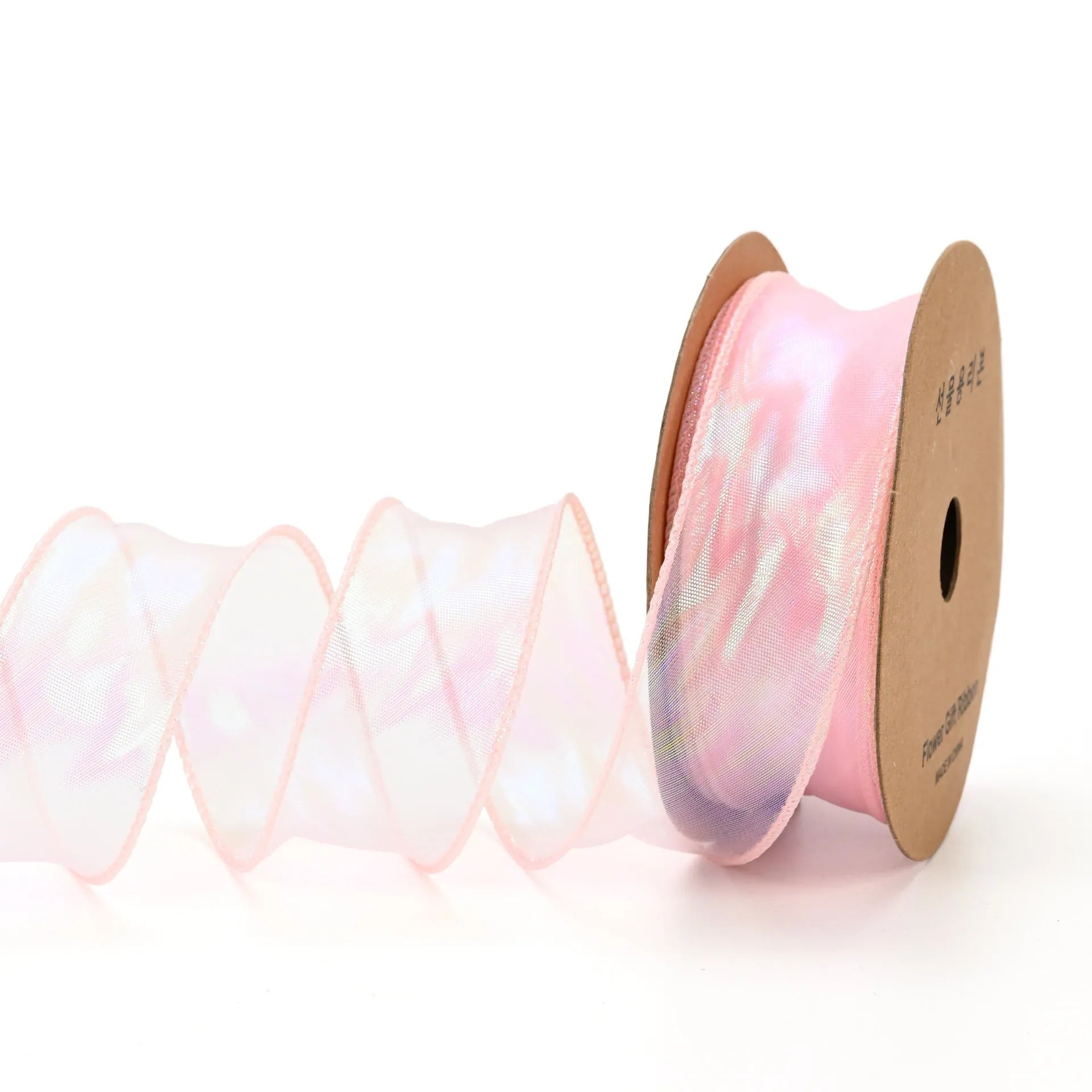 Roll of colourful fishtail yarn mesh ribbon showing its textured, wavy edge, with a colour selection including pink, yellow, and blue.
