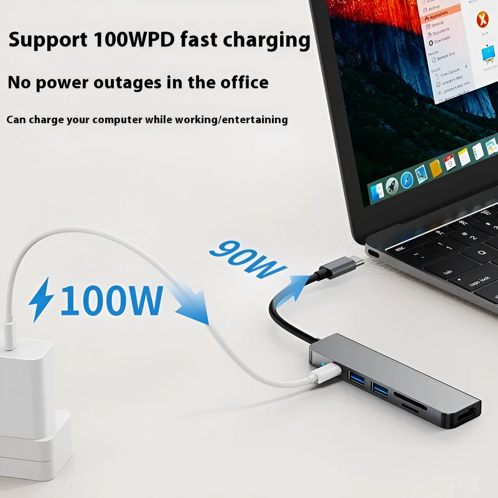 Silver aluminium USB-C expansion dock showing six ports including HDMI, USB 3.0, USB-C PD charging, and card readers