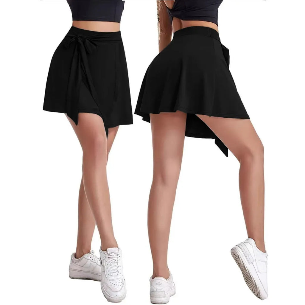 Black thigh-length sports skirt with built-in shorts, high waist, and shoulder straps laid flat.