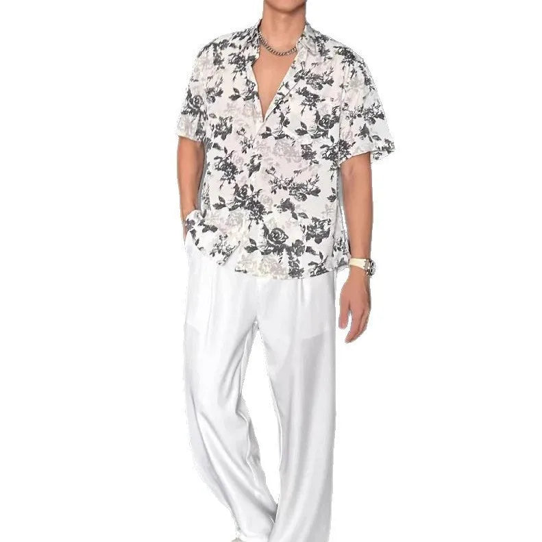 Loose fit floral printed short sleeve shirt in black, hanging on a hanger.