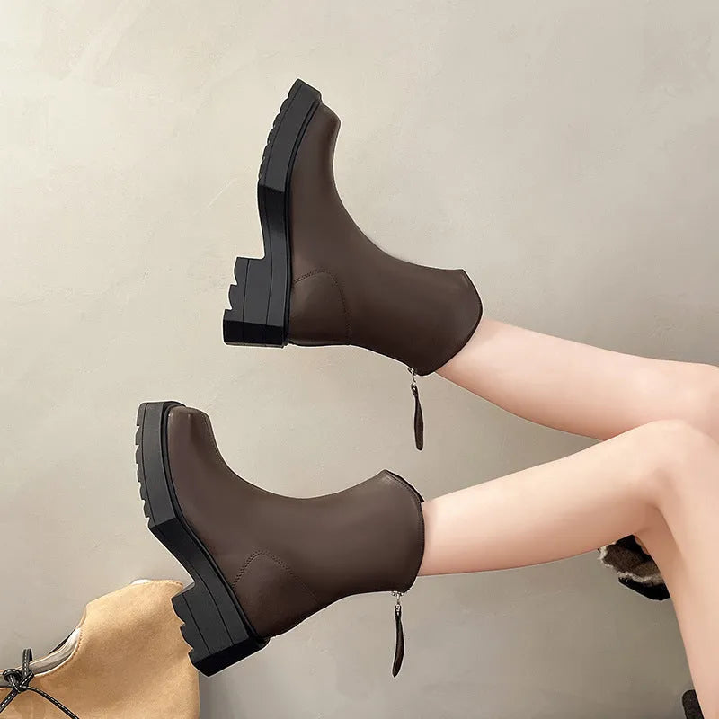 Women's black platform Martin boots with a square toe, chunky sole, and rear zip fastener