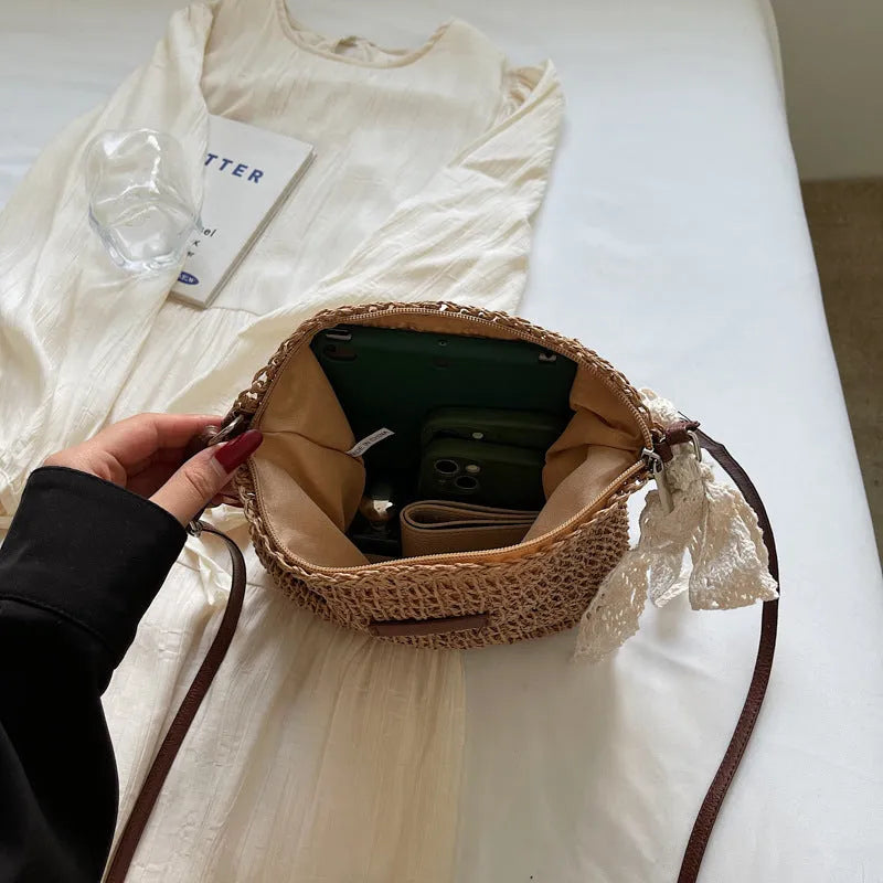 Women's straw woven messenger bag with hollowed design in khaki colour, showing vertical square shape and shoulder strap