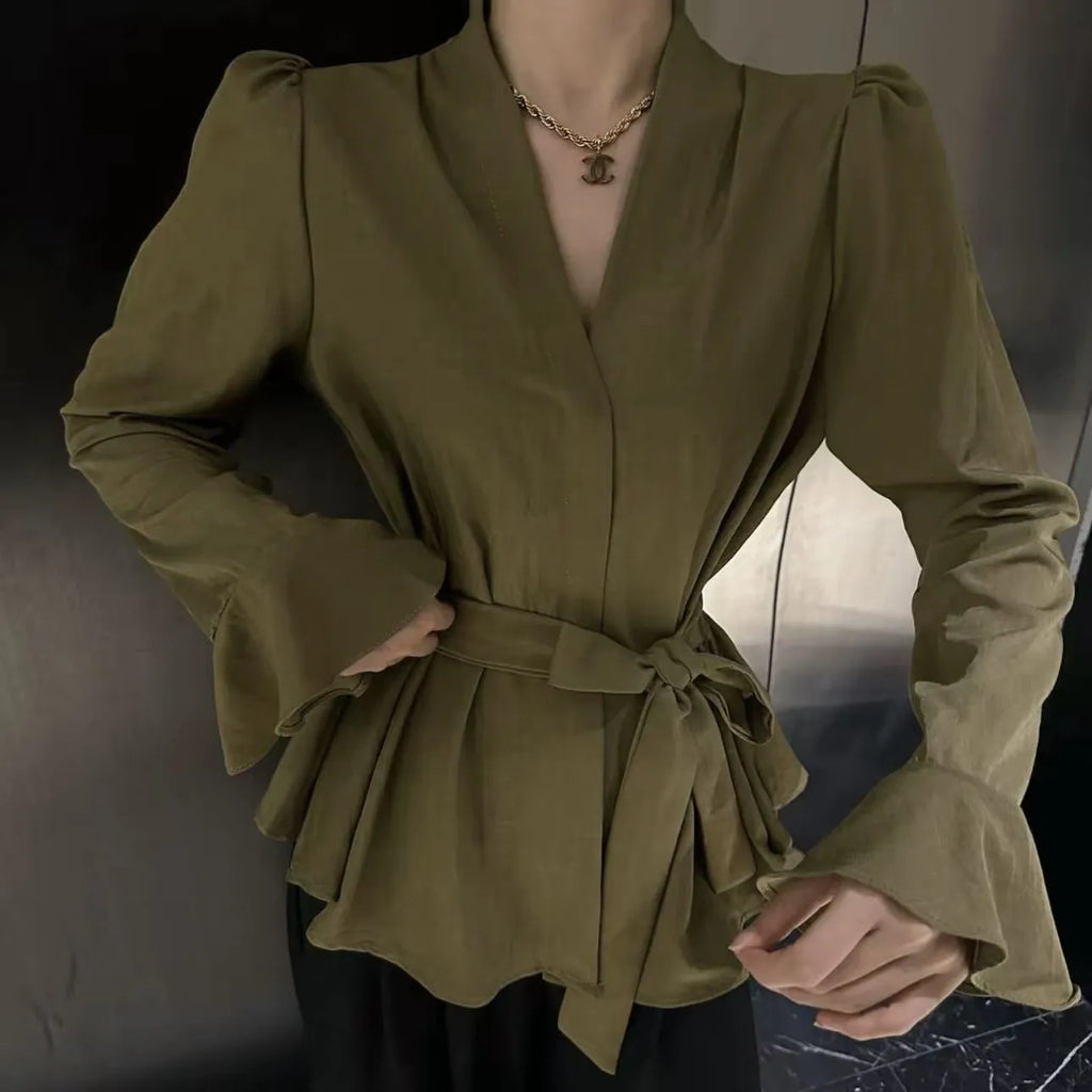 Women's black French-style long sleeve shirt with irregular collar, bell sleeves, and a tied front.