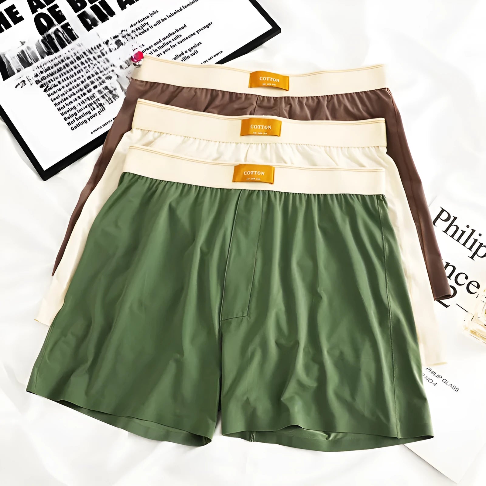 Pack of three men's solid colour loose fit ice silk nylon underwear on a mid waist mannequin.