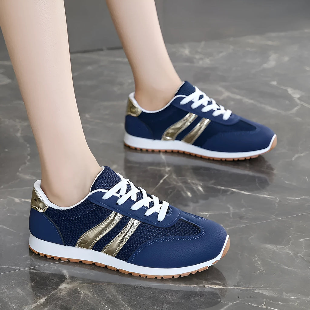 Blue women's lace-up tennis shoes with cross shoulder straps and a round toe