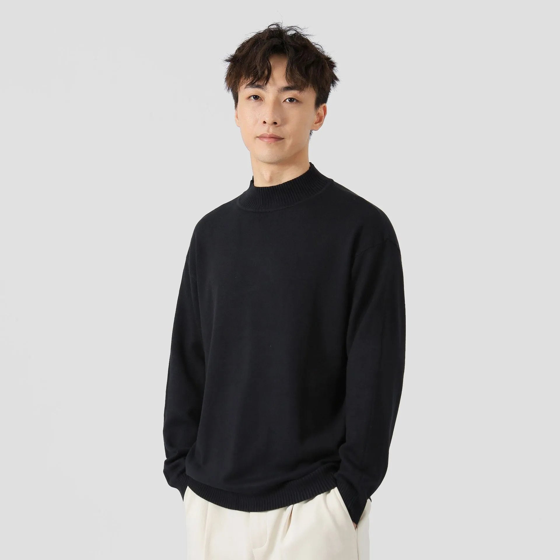 Man wearing a loose-fit army green long-sleeved pullover sweater for casual wear.