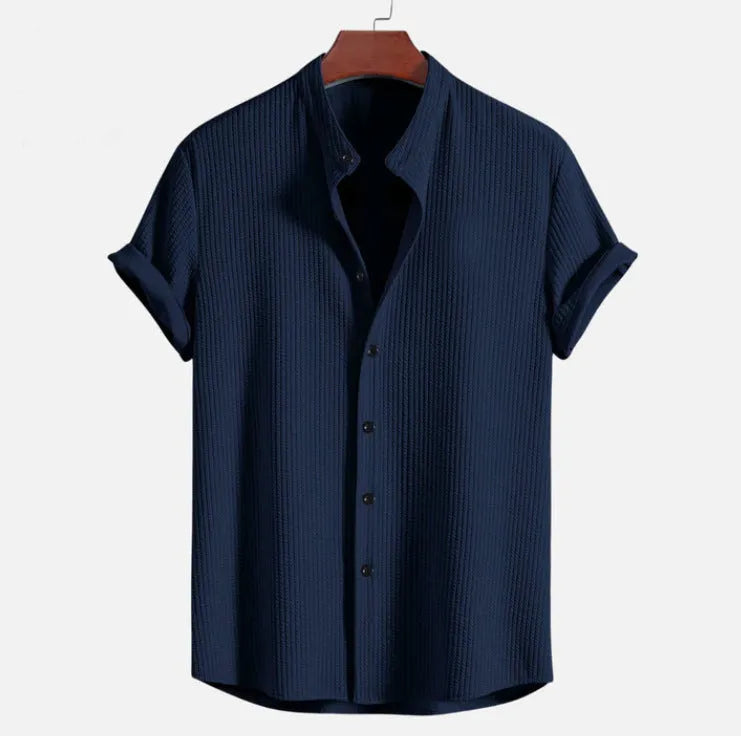 Men's loose-fitting short sleeve shirt in light blue polyester fabric on a hanger.