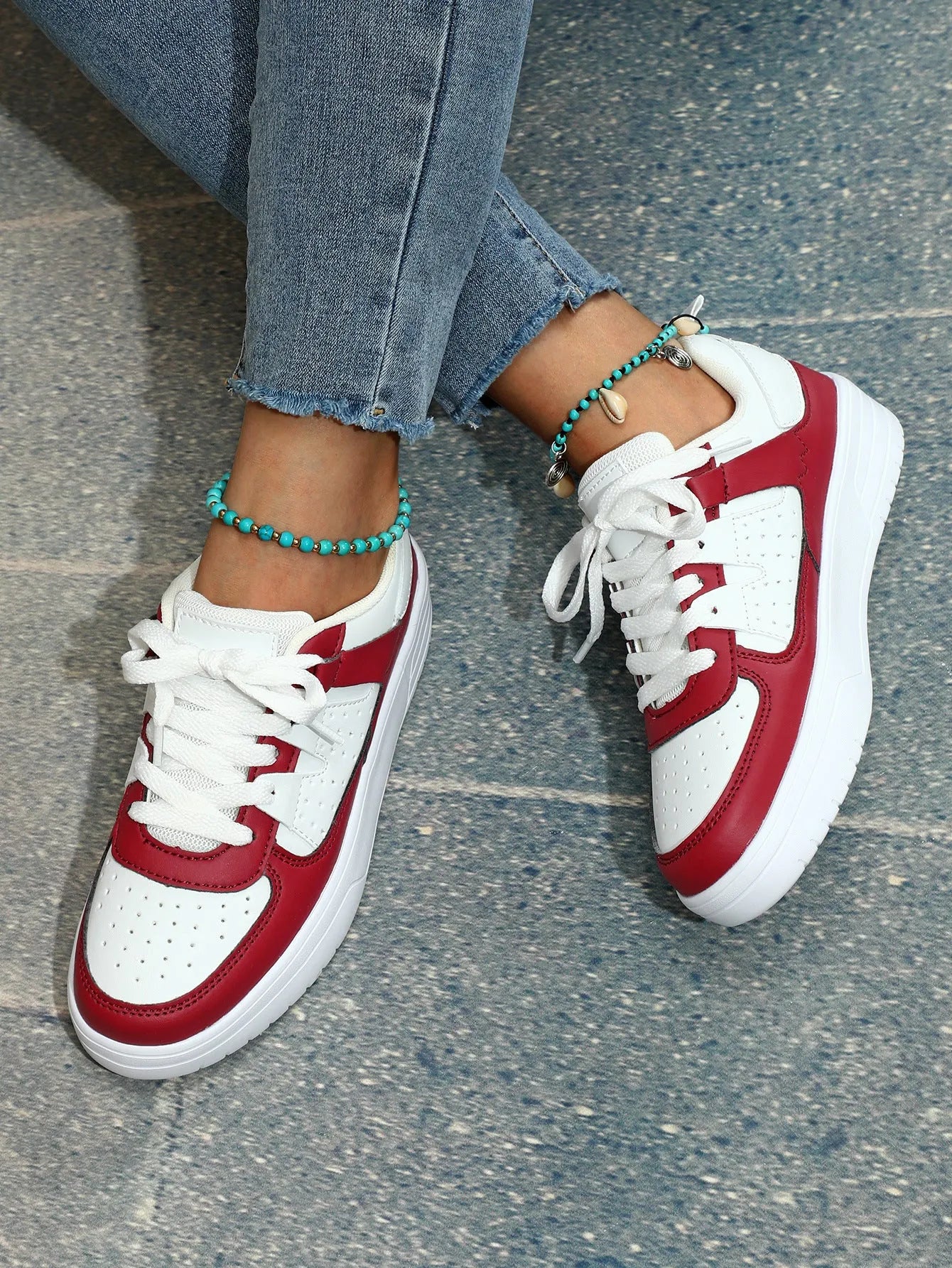Pair of solid colour low heel lace-up board shoes with artificial PU upper and rubber sole