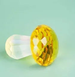 Colourful geometric crystal mushroom decoration in transparent, green, red, or yellow, 40mm by 53mm.