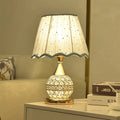 Gold crystal desk lamp with geometric design and iron art base on wooden surface
