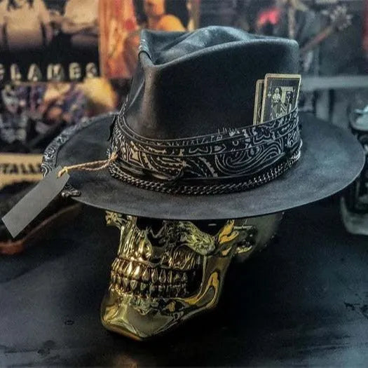 Handmade black wool felt skull hat with conical crown and blue denim accent band, shown from the side.