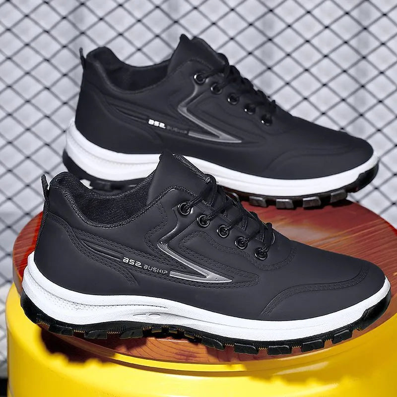 Men's black and grey waterproof PU casual shoes with a pointed toe and flat plastic sole on a white background.
