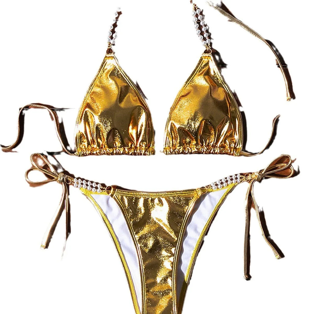 Gold women's halter lace-up bikini swimsuit with pearl chain detailing on mannequin
