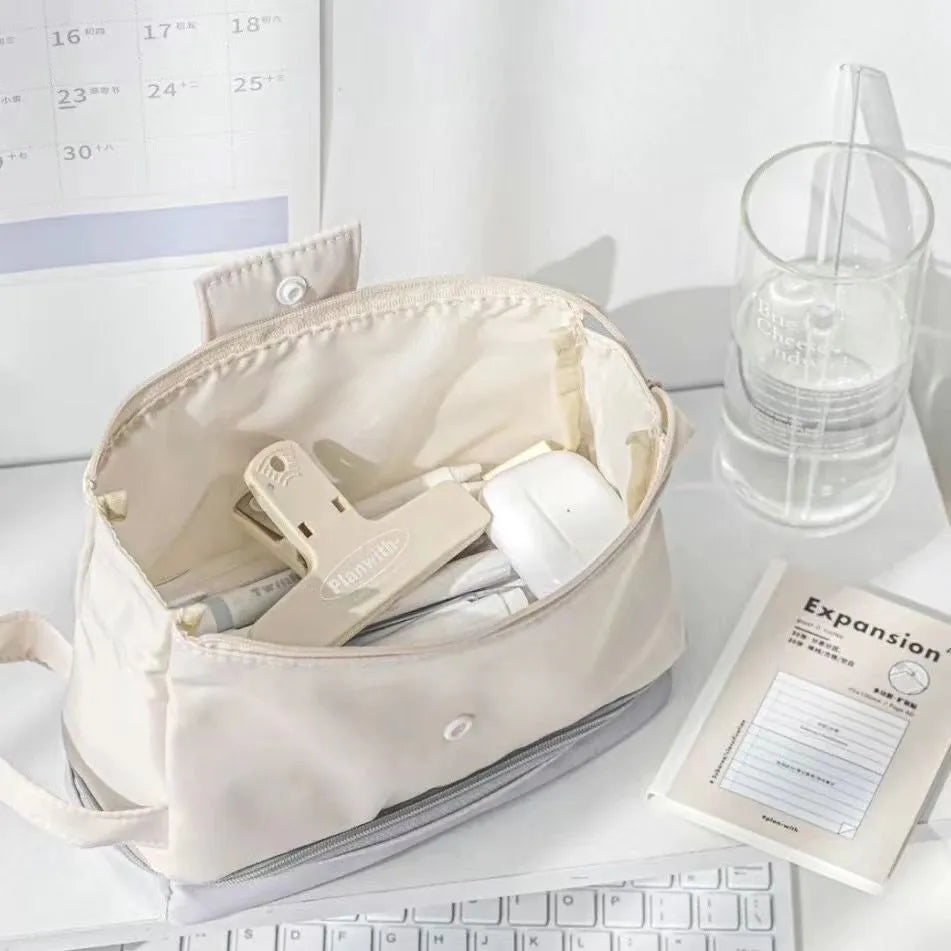 Fashion student pencil case in beige, blue, and navy blue, showing double layer open design.