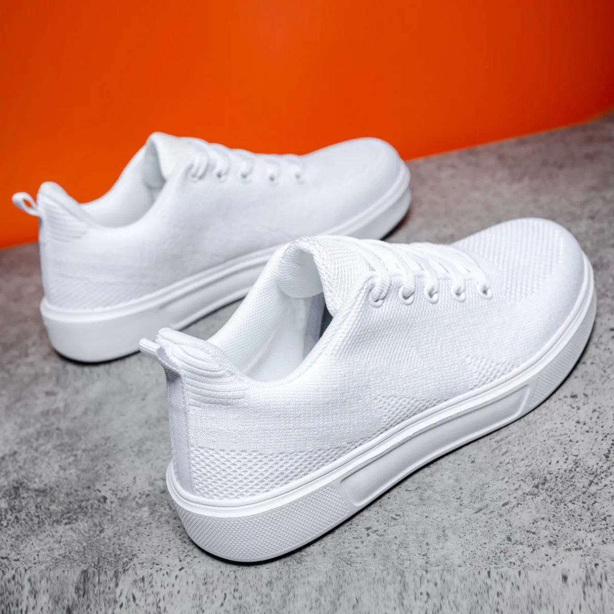 Unisex casual sports shoes with thick EVA sole and mesh upper in black and white colour options