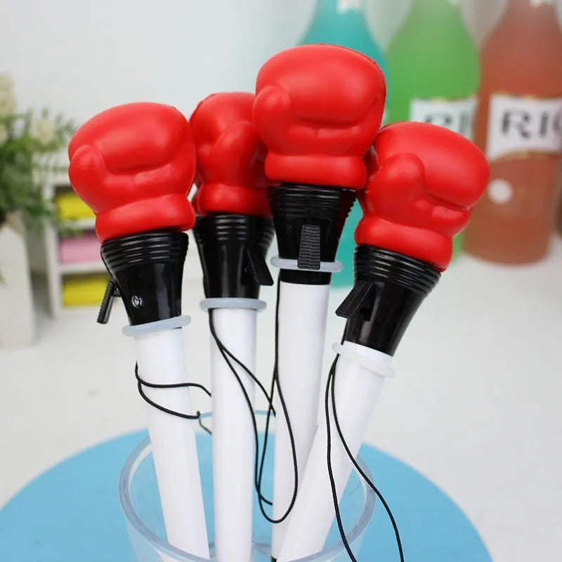 Set of four black creative pressure relief pens with boxing figure press-to-eject mechanism.