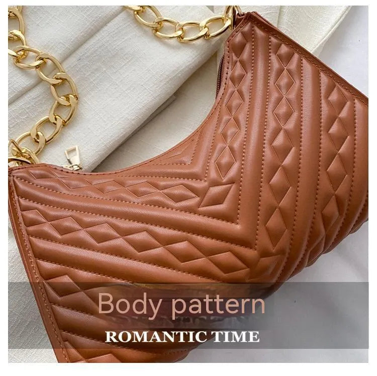 Brown vertical PU leather shoulder bag with a silver pleated chain strap and a soft handle.