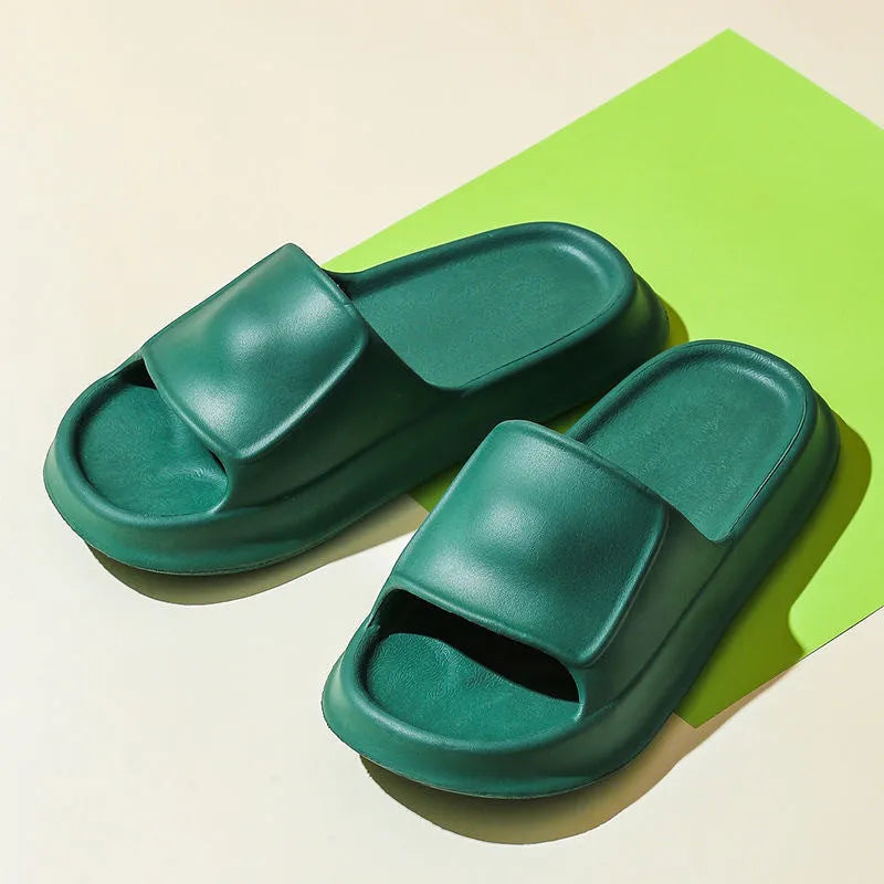 Pair of white EVA flip-flop slippers with a thick, textured sole on a tiled floor.