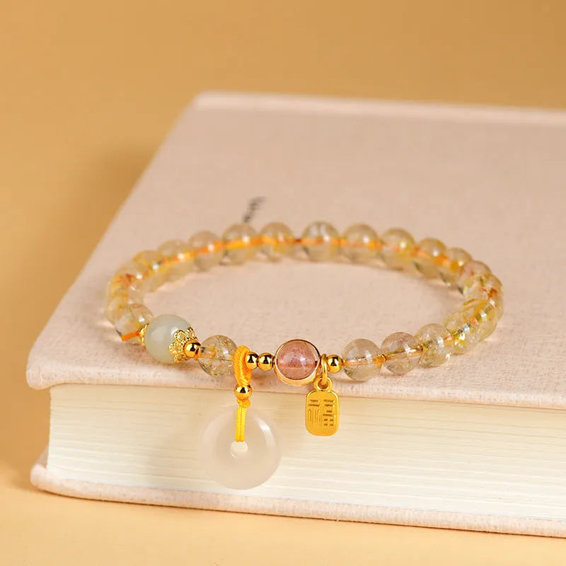 Gold rutilated quartz crystal bracelet with geometric design and safety buckle