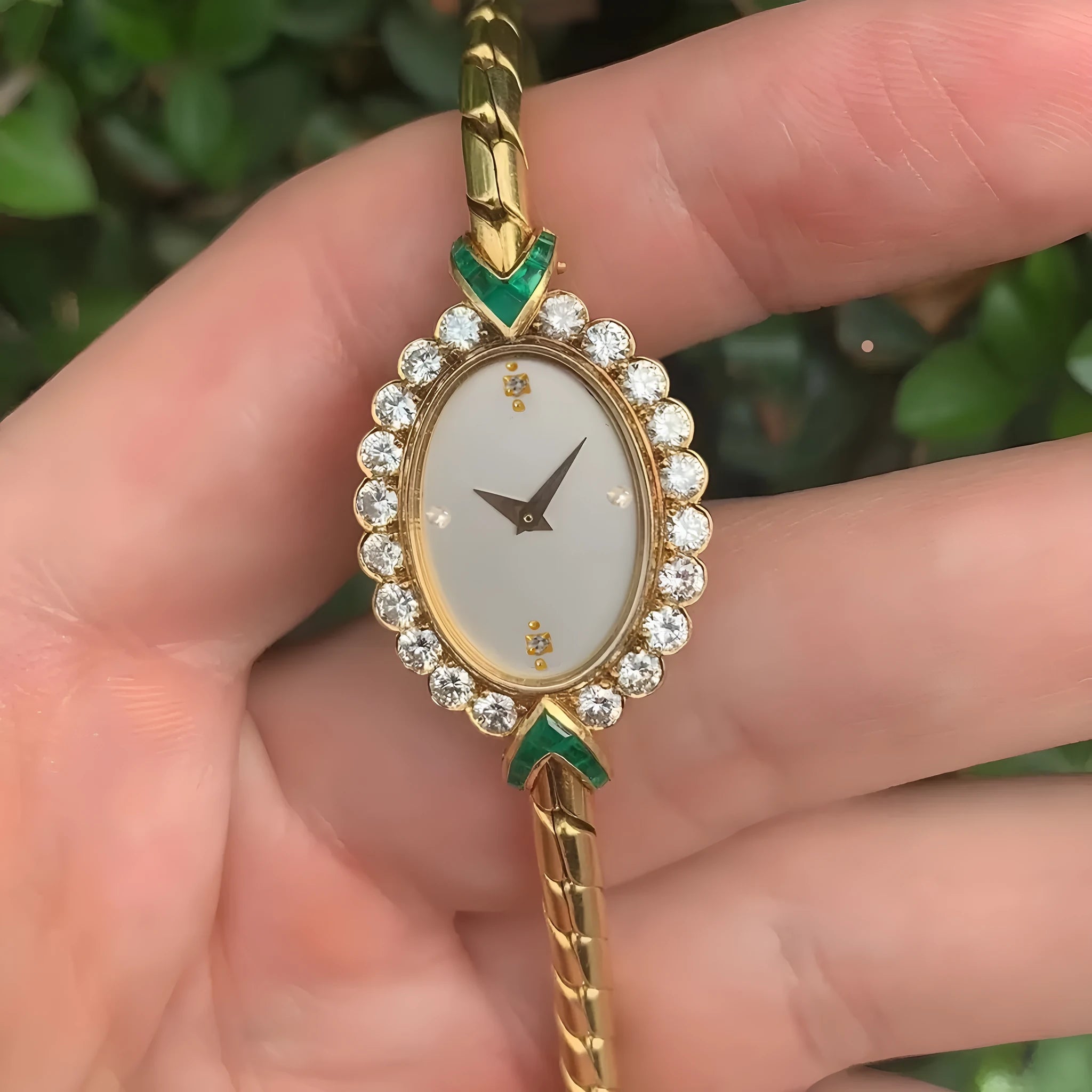 European small gold women's watch with handmade rhinestone inlay and adjustable strap on light background
