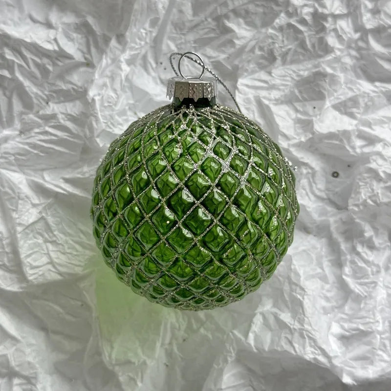 Handmade glass Christmas bauble 8cm diameter in green on branch