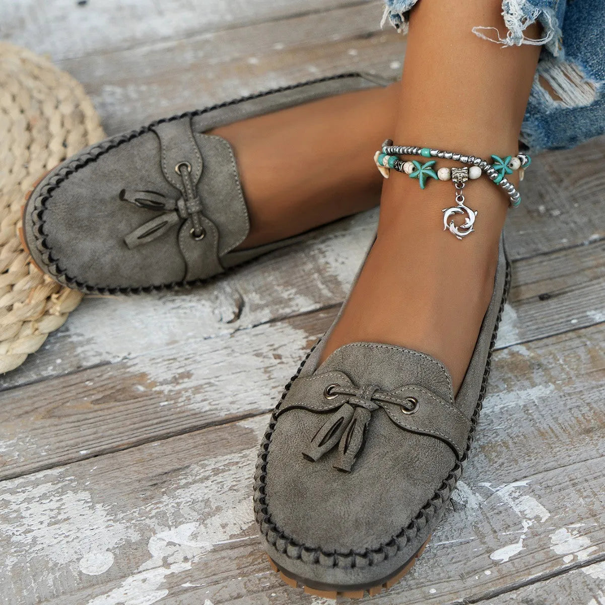 Women's casual suede flat shoes with a bow decoration, shown in a solid colour with a round toe and low heel.