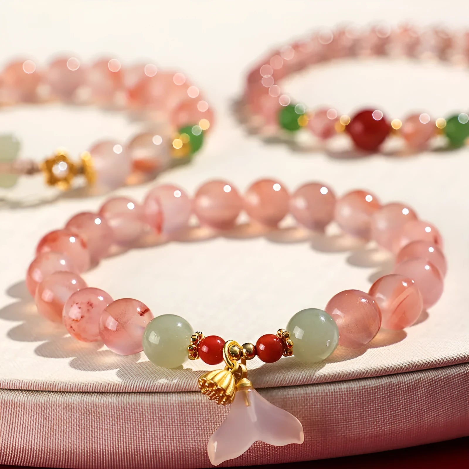 Women's ice floating south red white agate fishtail bracelet showing natural stone colour variation and textured design