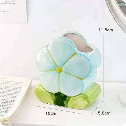 Ceramic pen holder box with floral pattern for desk organisation.