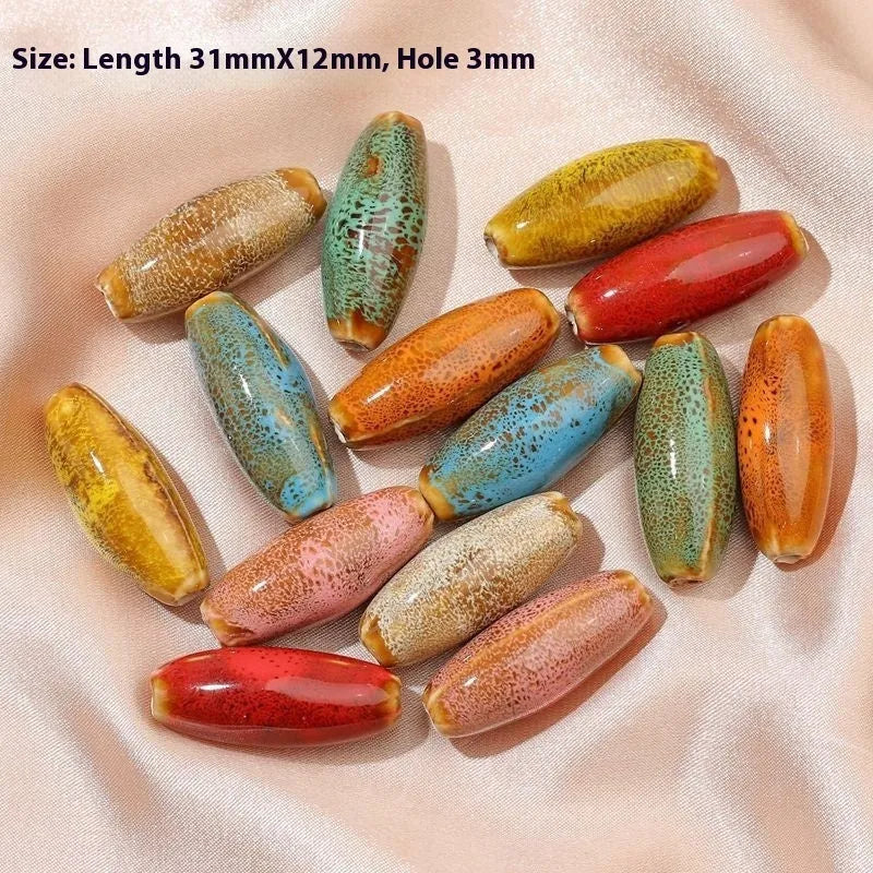 Assorted high-temperature fired ceramic bullet beads in pink, yellow, blue, red, coffee, green, orange, and mixed glaze colours.