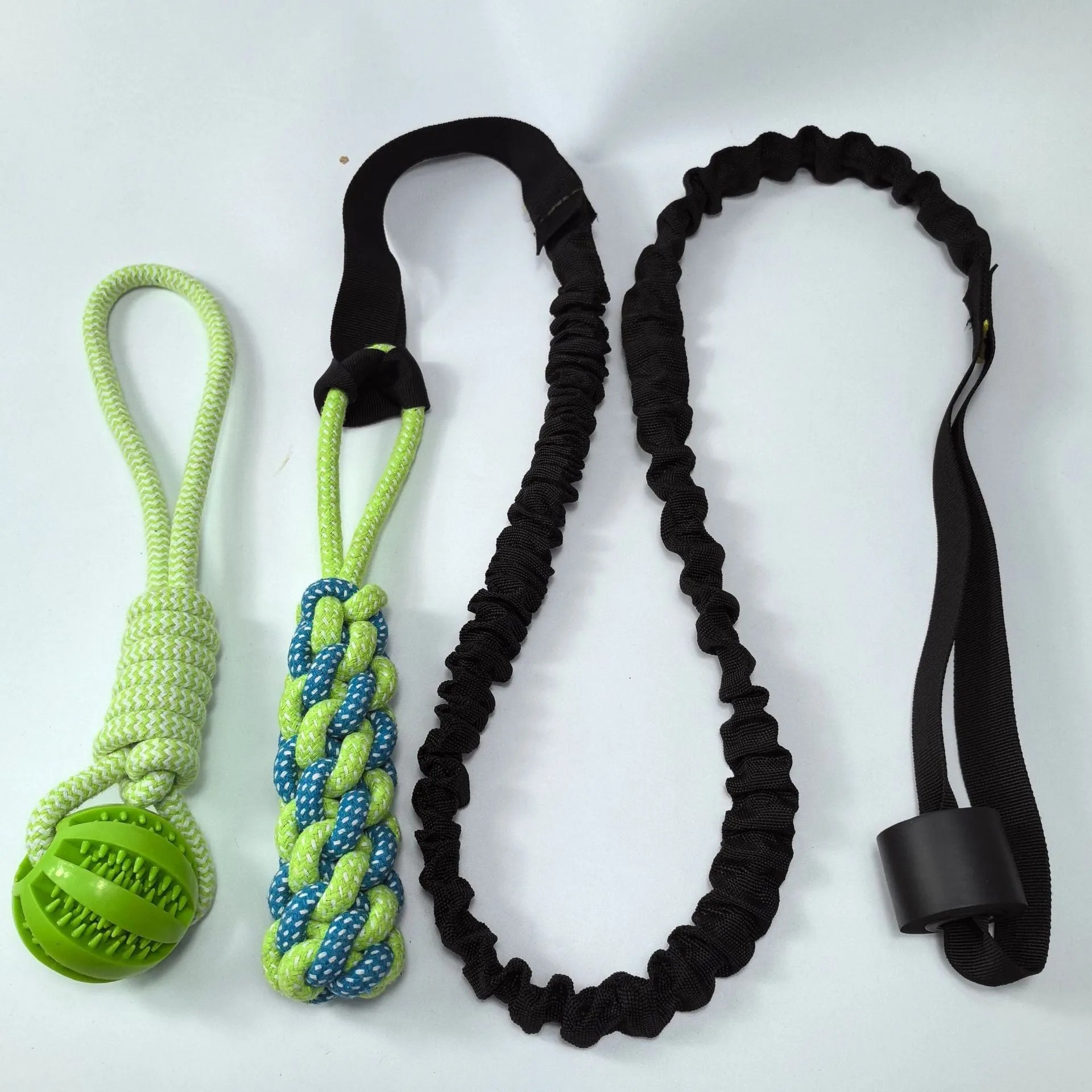 Green cotton rope dog tug toy with a knotted ball handle on a white background.
