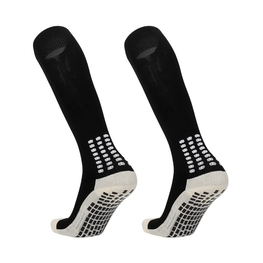 Solid colour polyester football socks in long tube style with multiple colour options including black, white, red, and green.