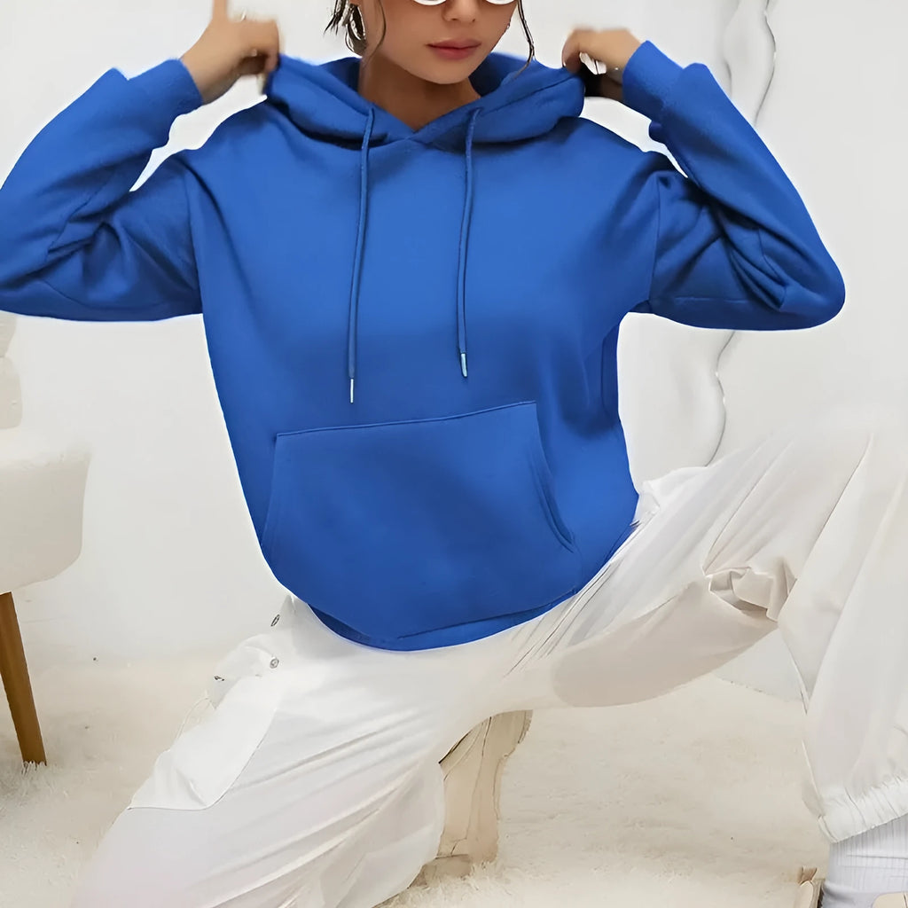 Women's loose grey drawstring hoodie with front kangaroo pockets, on a hanger.