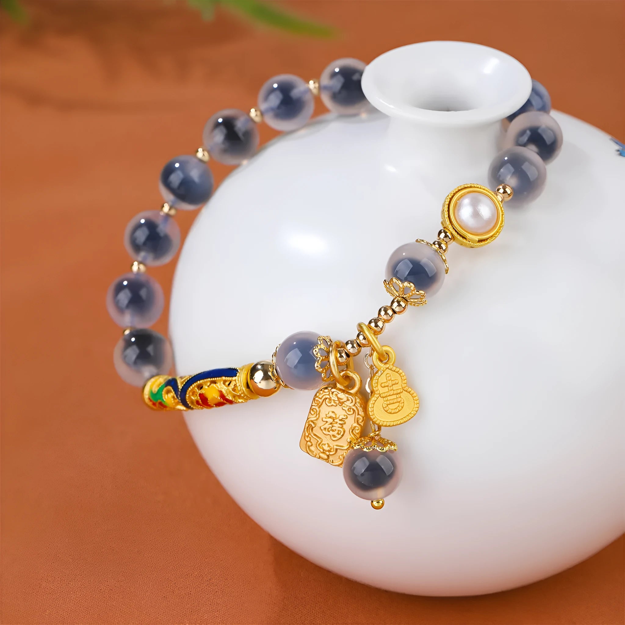 Handmade sugar heart agate bracelet with retro ethnic design on a wrist.