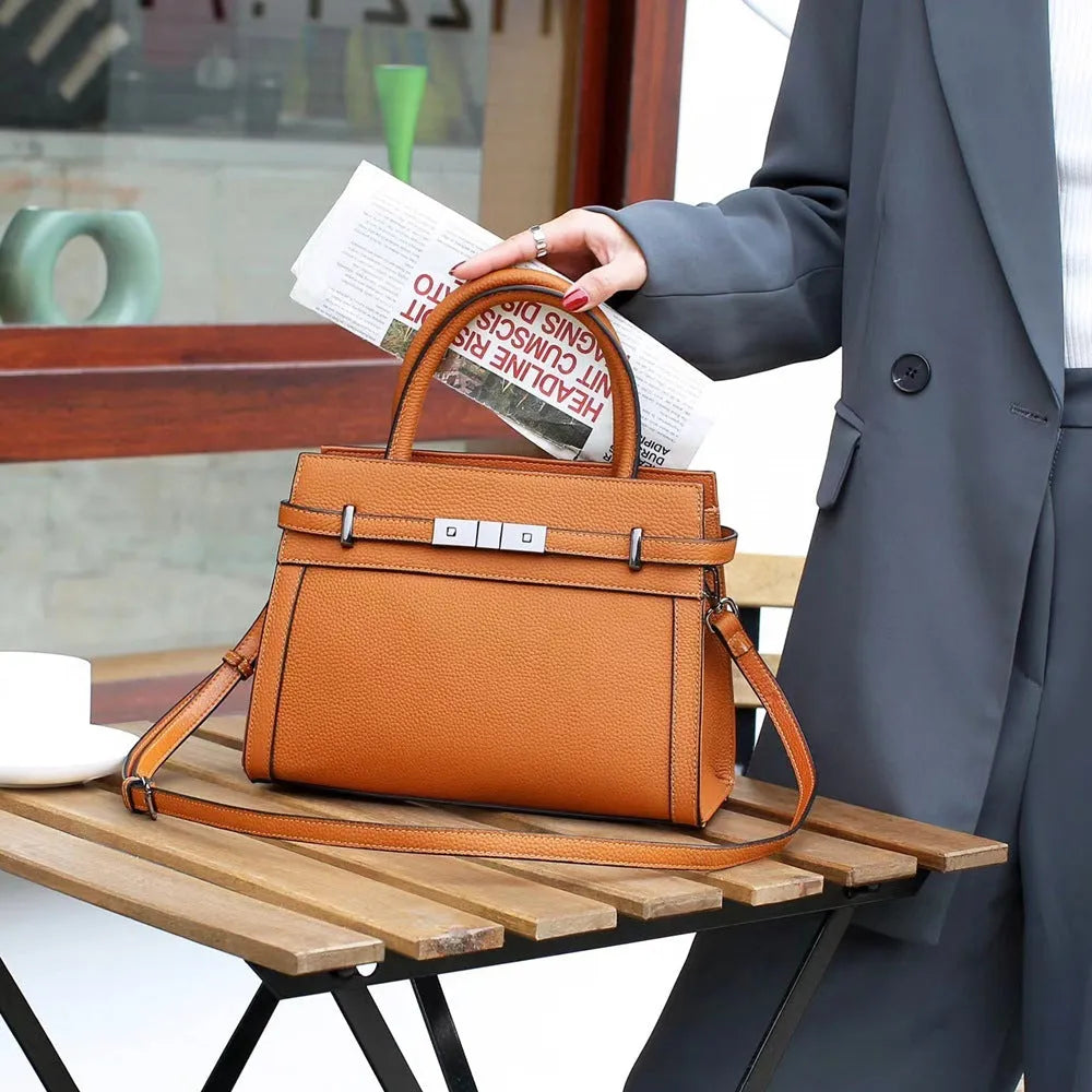 Small square horizontal genuine leather shoulder bag in almond green with visible stitching and shoulder strap