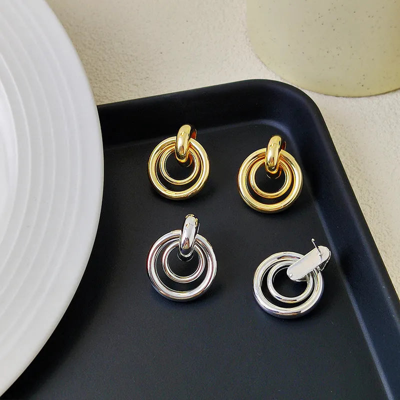Geometric round ring earrings with irregular styling in gold and silver colour options