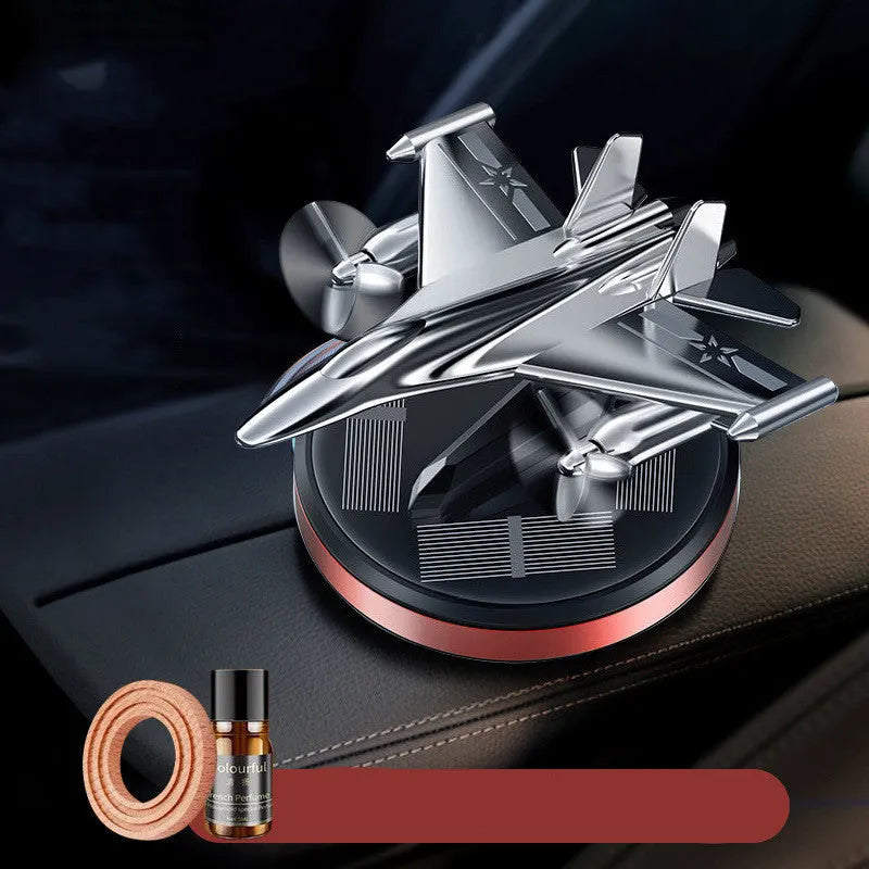 Solar powered rotating aluminium alloy fighter jet shaped car air freshener ornament in silver colour