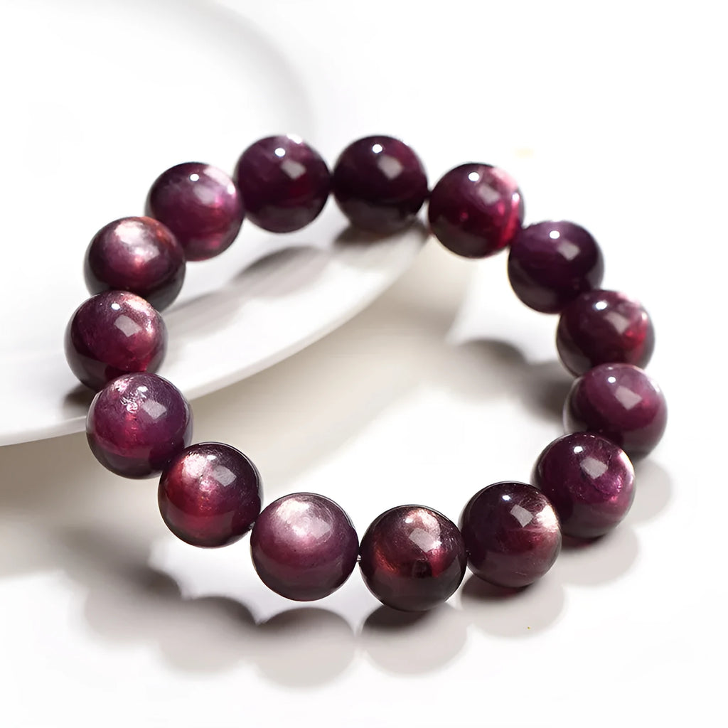 Purple lepidolite crystal round beads bracelet on a wrist, showing polished gemstone beads.