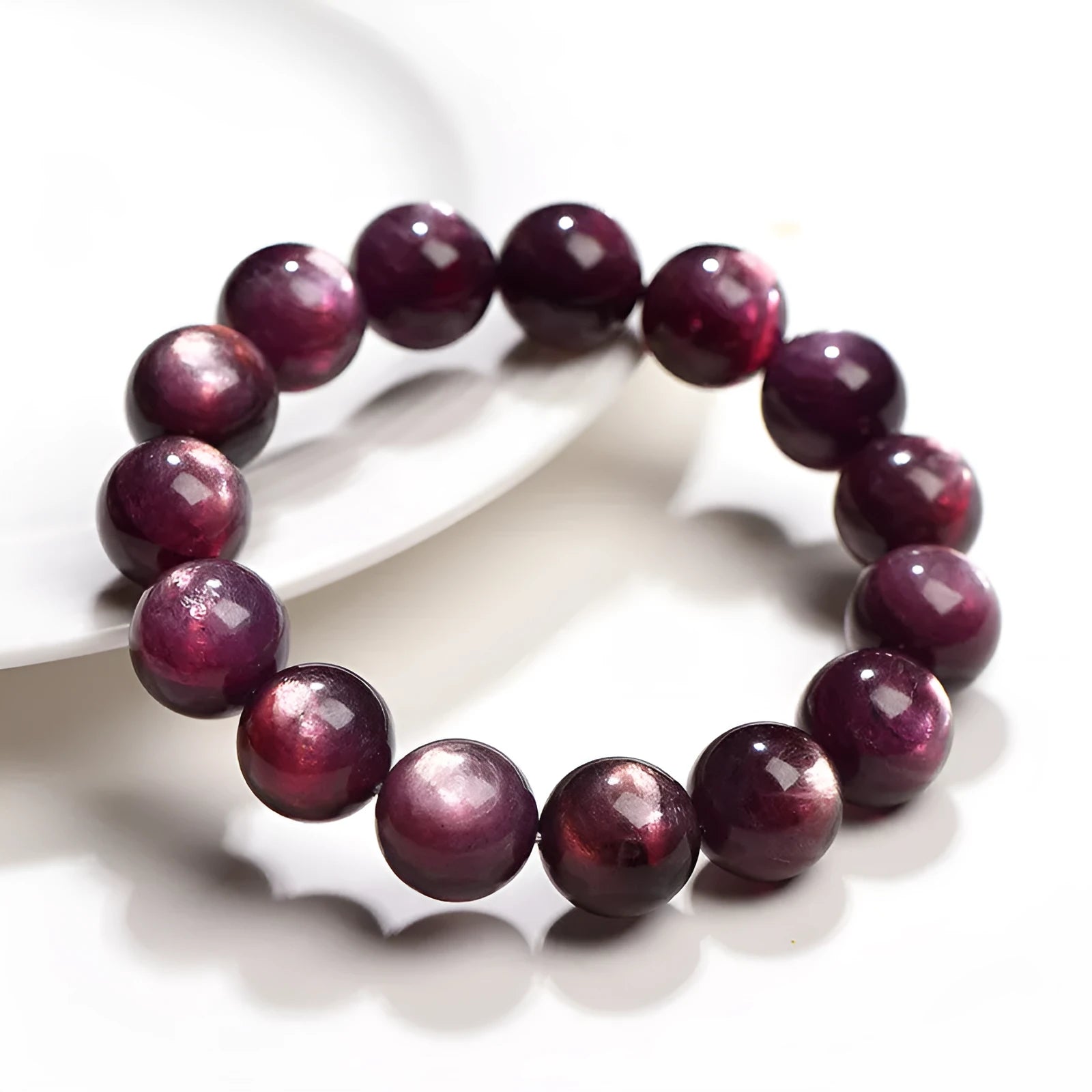 Purple lepidolite crystal round beads bracelet on a wrist, showing polished gemstone beads.