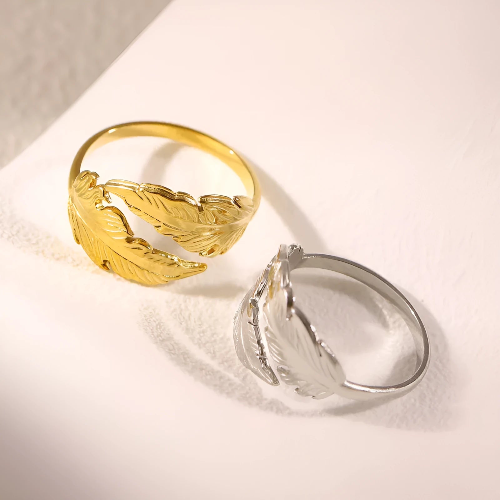 Women's stainless steel feather ring with adjustable opening in gold or silver finish