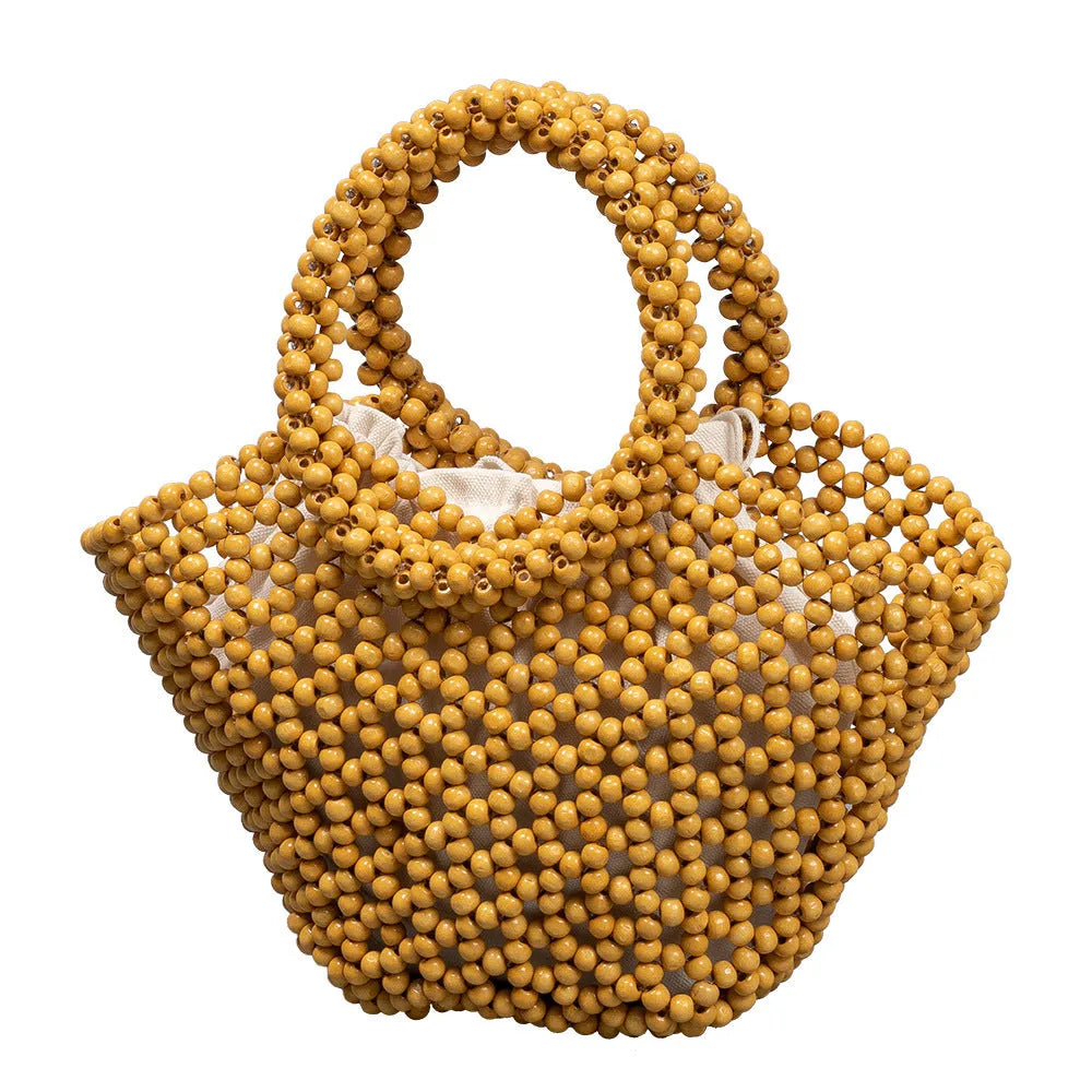 Hand-woven wooden bead beach bag in dumpling shape with strapless design.