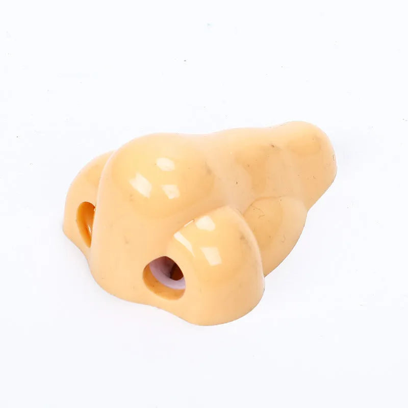 Flesh-coloured plastic manual pencil sharpener with a geometry shape and large nostril.
