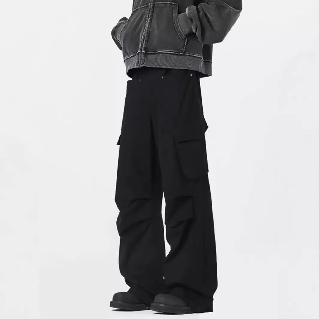 Man wearing retro style high-waisted straight leg casual trousers in black.