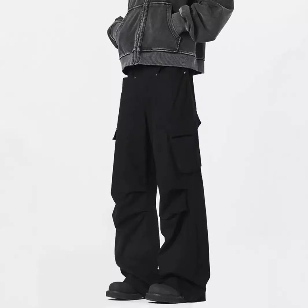 Man wearing retro style high-waisted straight leg casual trousers in black.