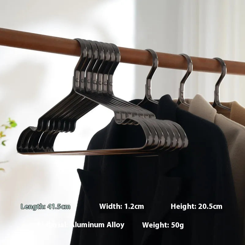 Elegant black non-slip clothes hanger for shirts, trousers and ties on a rail.