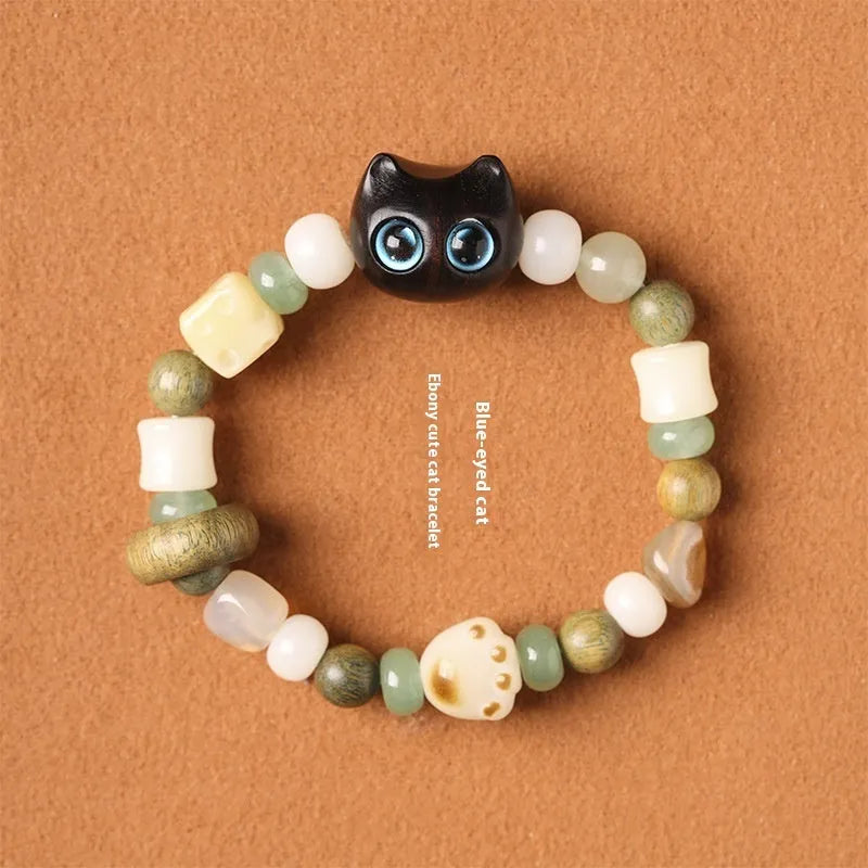 Hand-woven adjustable bracelet with bodhi seeds, jade beads, and a cartoon cat's paw guajacwood charm